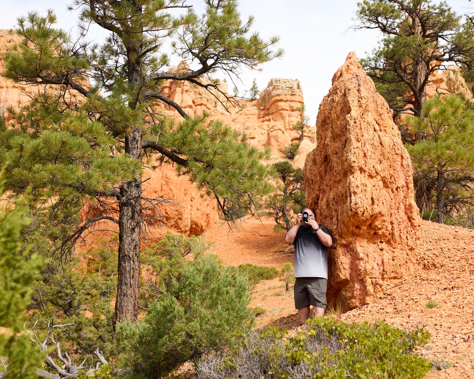 A Combat 2 Camera participant photographing a red rock landscape